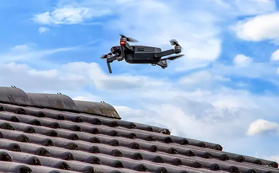 Un drone survolant un toit de tuiles.